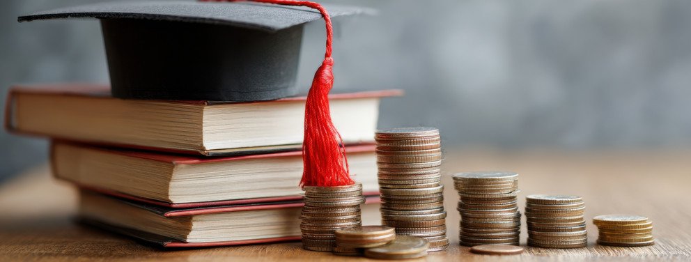 Graduation cap with books and coins