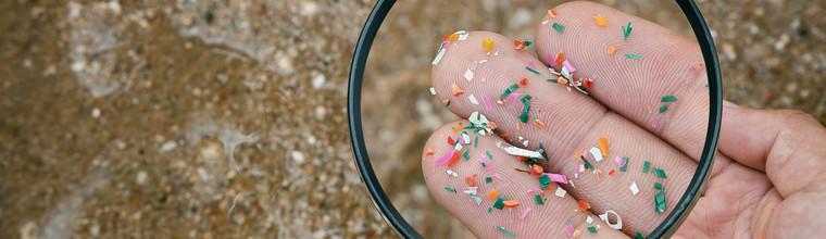 Close up side shot of microplastics lay on people hand. Concept of water pollution and global warming. Climate change idea. micro plastics concept in food and water or sea